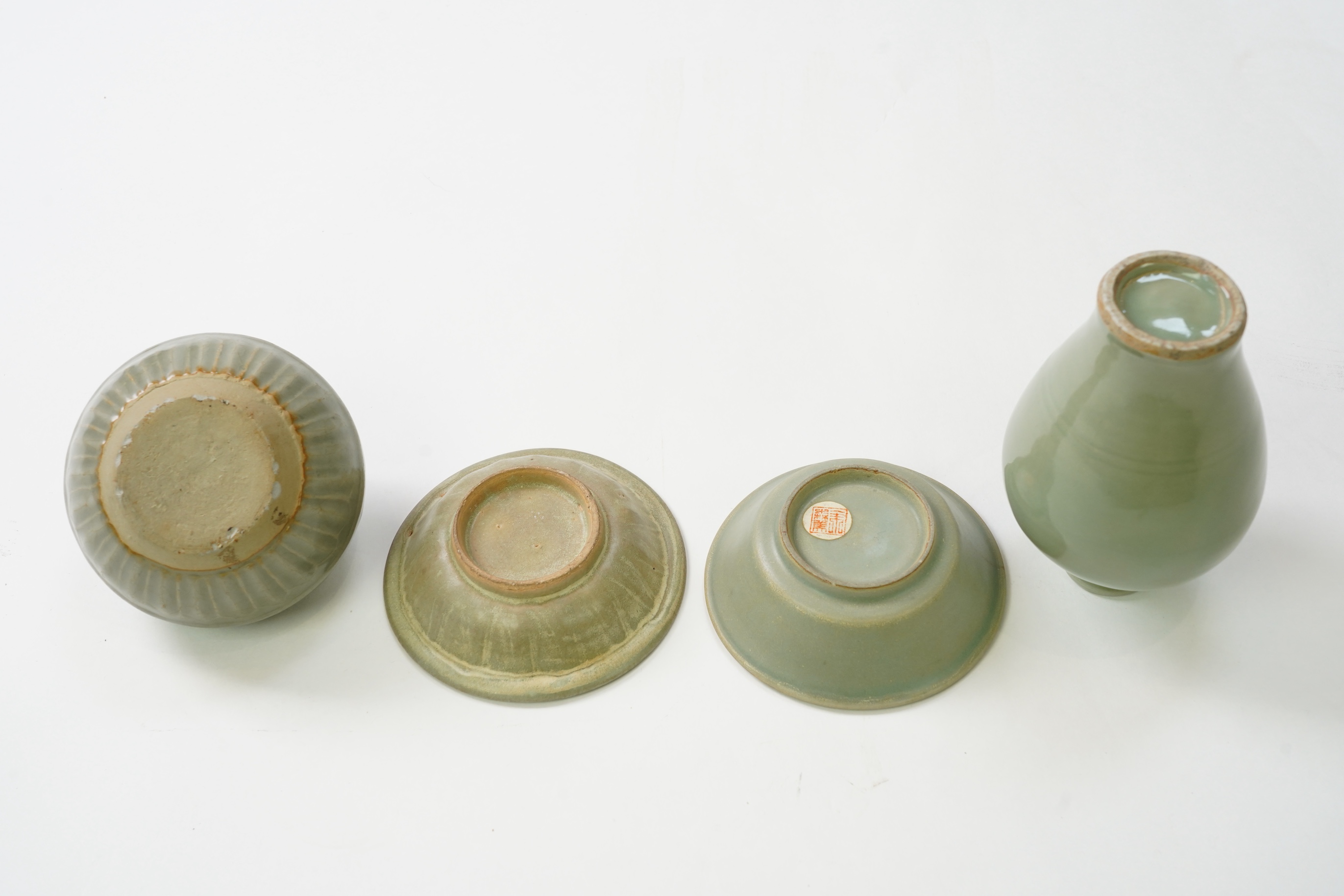 A group of four Chinese Celadon wares - two vases and two dishes, tallest vase 16cm.